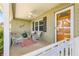 Inviting front porch featuring comfortable seating and a charming, welcoming ambiance at 9750 Sw 97Th Pl, Ocala, FL 34481