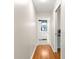 Hallway that reveals view of bathroom with white cabinets and stylish fixtures at 9750 Sw 97Th Pl, Ocala, FL 34481