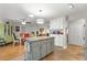 Open kitchen with a center island, granite countertops, and views of the dining area at 9750 Sw 97Th Pl, Ocala, FL 34481