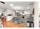 Bright kitchen features white cabinets, stainless appliances, center island, and cozy breakfast bar with seating at 9750 Sw 97Th Pl, Ocala, FL 34481