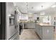 Modern kitchen featuring stainless steel appliances, granite countertops, and a center island at 9750 Sw 97Th Pl, Ocala, FL 34481