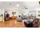 Bright living room featuring hardwood floors, vaulted ceilings with skylight, and comfortable furnishings at 9750 Sw 97Th Pl, Ocala, FL 34481