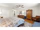 Comfortable main bedroom features wood floors, ceiling fan, warm furnishings, and walk in closet at 9750 Sw 97Th Pl, Ocala, FL 34481