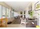 Inviting sunroom with ample seating, a mini fridge, and great natural light at 9750 Sw 97Th Pl, Ocala, FL 34481