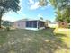 Spacious backyard features a screened lanai, providing an ideal space for outdoor relaxation and entertaining guests at 1001 Ne 22Nd Ave, Ocala, FL 34470
