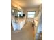 Traditional bathroom featuring double sinks, a built-in tub and neutral floral wallpaper throughout at 1001 Ne 22Nd Ave, Ocala, FL 34470