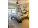 Comfortable bedroom featuring a blue bedspread, ceiling fan and a large window for natural light at 1001 Ne 22Nd Ave, Ocala, FL 34470
