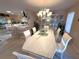Bright dining room featuring a marble table, elegant chandelier, and views of the kitchen and breakfast bar at 1001 Ne 22Nd Ave, Ocala, FL 34470