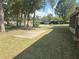 Expansive front yard showcasing a well-maintained lawn and shaded by mature trees, creating a serene setting at 1001 Ne 22Nd Ave, Ocala, FL 34470