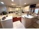 Bright eat-in kitchen with modern appliances, white cabinets and a breakfast bar area at 1001 Ne 22Nd Ave, Ocala, FL 34470