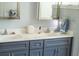 Double vanity bathroom with neutral walls, chrome fixtures and gray cabinets at 10208 Se 170 Pl, Summerfield, FL 34491