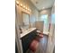 Bathroom featuring a vanity, grey cabinetry, and walk-in shower with glass partition at 10208 Se 170 Pl, Summerfield, FL 34491