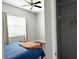 Bedroom featuring a ceiling fan, wood-look floors, and a closet with shelving at 10208 Se 170 Pl, Summerfield, FL 34491