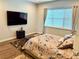 Bedroom with mounted TV, natural light, and comfortable carpeting at 10208 Se 170 Pl, Summerfield, FL 34491