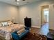 Well-lit bedroom with a view into bathroom, wood floors, and neutral color palette at 10208 Se 170 Pl, Summerfield, FL 34491