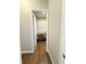 A walk-in closet with wood-look floors and built-in shelving at 10208 Se 170 Pl, Summerfield, FL 34491