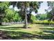 Expansive front lawn with mature trees offering shade and privacy and dark wooden perimeter fencing at 10208 Se 170 Pl, Summerfield, FL 34491
