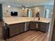Modern kitchen featuring gray cabinets, marble countertops, stainless steel appliances and wood flooring at 10208 Se 170 Pl, Summerfield, FL 34491