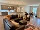 Spacious living area with leather sectional, massage chair, open kitchen and dining area at 10208 Se 170 Pl, Summerfield, FL 34491