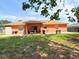 Lush backyard with covered patio area, perfect for relaxing outdoors at 14 Dogwood Drive Radl, Ocala, FL 34472