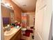 Well-lit bathroom features vanity, toilet, and shower/tub combo with colorful curtain at 14 Dogwood Drive Radl, Ocala, FL 34472
