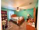 Bedroom features teal walls, ceiling fan, wooden furniture, and carpet flooring at 14 Dogwood Drive Radl, Ocala, FL 34472