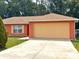 Charming one-story home with a spacious driveway and well-maintained lawn at 14 Dogwood Drive Radl, Ocala, FL 34472