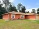 Single-story home with a well-maintained lawn and charming window shutters at 14 Dogwood Drive Radl, Ocala, FL 34472