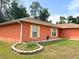 Single-story home with a well-maintained lawn and charming window shutters at 14 Dogwood Drive Radl, Ocala, FL 34472