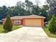 Charming one-story home with a spacious driveway and well-maintained lawn at 14 Dogwood Drive Radl, Ocala, FL 34472