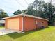 Side angle of the house with a two-car garage and well-maintained landscaping at 14 Dogwood Drive Radl, Ocala, FL 34472