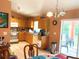Bright kitchen area with tile flooring, wooden cabinets, and sliding glass door at 14 Dogwood Drive Radl, Ocala, FL 34472