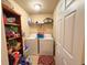A functional laundry room featuring a washer, dryer, shelving, and ample storage space at 14 Dogwood Drive Radl, Ocala, FL 34472
