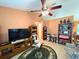 The living room has tile floors, ceiling fan, TV, cabinets, and furniture at 14 Dogwood Drive Radl, Ocala, FL 34472