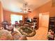Comfortable living room features tile floors, ceiling fan, entertainment center, and furniture at 14 Dogwood Drive Radl, Ocala, FL 34472