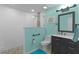Updated bathroom with walk-in shower, blue accent wall, dark vanity, and tile flooring at 14330 Sw 79Th Ter, Ocala, FL 34473