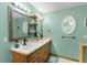 Elegant bathroom with dual sinks, decorative mirrors, and natural lighting creating a spa-like atmosphere at 14330 Sw 79Th Ter, Ocala, FL 34473