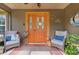 Welcoming front porch with a colorful door and comfortable seating at 14330 Sw 79Th Ter, Ocala, FL 34473
