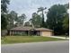 Charming single-story home with lush trees, a spacious lawn and an attached garage at 14330 Sw 79Th Ter, Ocala, FL 34473