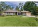 Charming single-story home boasts lush lawn, screened entry, and attached garage at 14330 Sw 79Th Ter, Ocala, FL 34473
