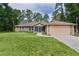 Charming one-story home with a well-maintained lawn and attached garage at 14330 Sw 79Th Ter, Ocala, FL 34473