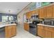 Stylish kitchen featuring wooden cabinetry and stainless-steel appliances for a modern look at 14330 Sw 79Th Ter, Ocala, FL 34473