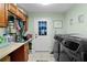 Laundry room with washer and dryer, wood cabinets, and neutral color walls at 14330 Sw 79Th Ter, Ocala, FL 34473