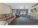 Spacious living room with comfortable furniture, blue accent wall, and ample natural light at 14330 Sw 79Th Ter, Ocala, FL 34473