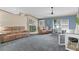 Large living room with two seating areas, light walls, and grey carpet at 14330 Sw 79Th Ter, Ocala, FL 34473