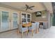 Covered patio with ceiling fan, outdoor dining table, and mounted television at 14330 Sw 79Th Ter, Ocala, FL 34473