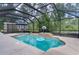 Screened-in pool area with a basketball hoop, patio furniture, and private yard at 14330 Sw 79Th Ter, Ocala, FL 34473