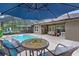 Beautifully designed pool patio with shaded umbrella table and outdoor dining area at 14330 Sw 79Th Ter, Ocala, FL 34473
