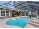 Relaxing screened-in pool area with an umbrella table and ample patio space at 14330 Sw 79Th Ter, Ocala, FL 34473