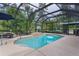 Gorgeous screened-in pool area featuring a refreshing swimming pool with an outdoor recreational area at 14330 Sw 79Th Ter, Ocala, FL 34473